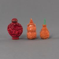<b>TWO CORAL SNUFF BOTTLES IN THE SHAPE OF A GOURD AND A RED SNUFF BOTTLE</b>