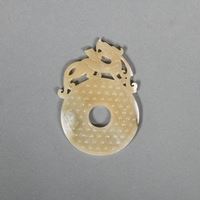 <b>A JADE BI-DISC WITH DRAGON IN ARCHAIC STYLE</b>