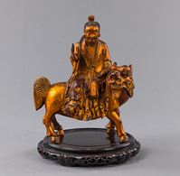 <b>A LACQUER-GILT WOOD FIGURE OF A DAOIST ON A MYTHICAL BEAST</b>