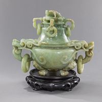 <b>A JADE LIDDED VESSEL WITH DRAGON HANDLES AND LOOSE RINGS</b>