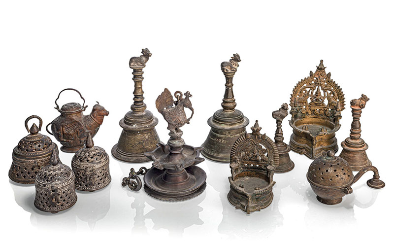 <b>A GROUP OF TWELVE VARIOUS BRONZE OBJECTS AMONG OTHERS HINGED BOXES, OILLAMPS AND BELLS</b>