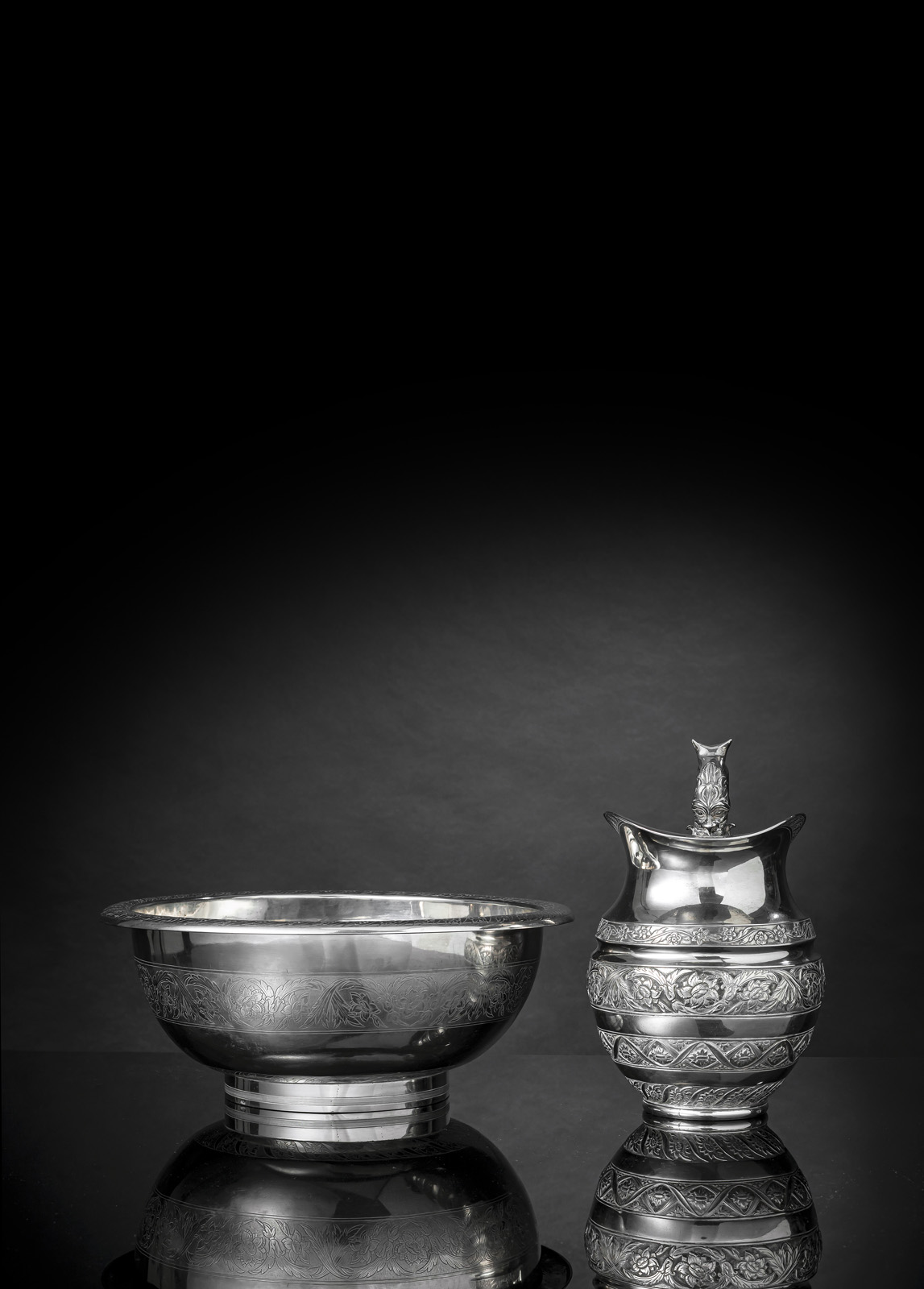 <b>A LARGE FLORAL TOOLED SILVER BOWL AND A JAR</b>
