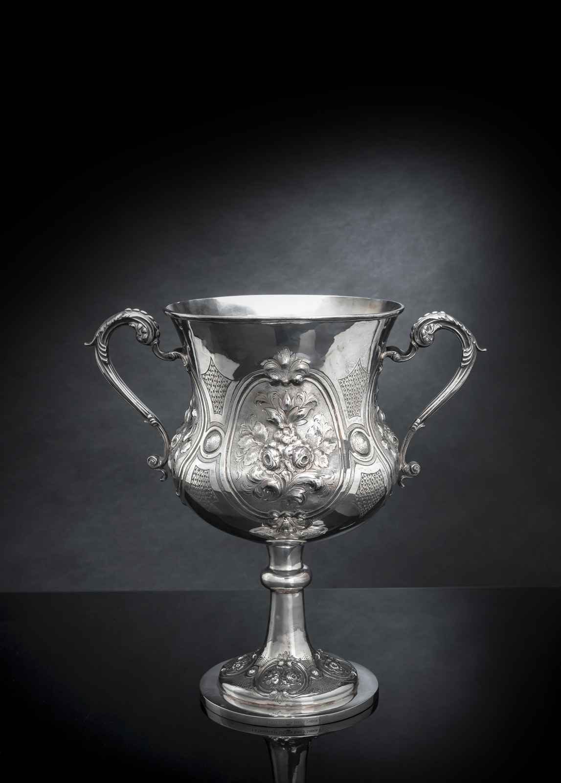 <b>A LARGE PARTIAL GILT FLORAL TOOLED CHASED SILVER CUP</b>