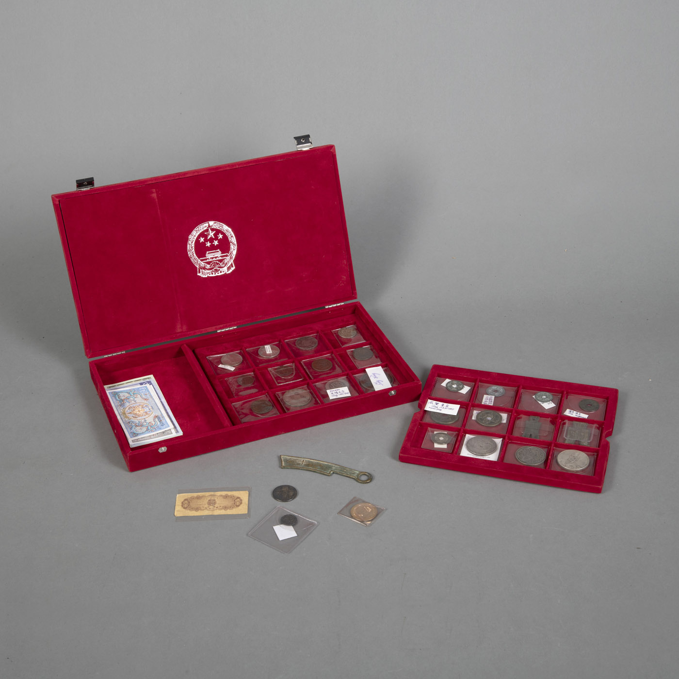 <b>A COLLECTION OF COINS, BANKNOTES AND POSTAGE STAMPS, IN A READ VELVET BOX</b>