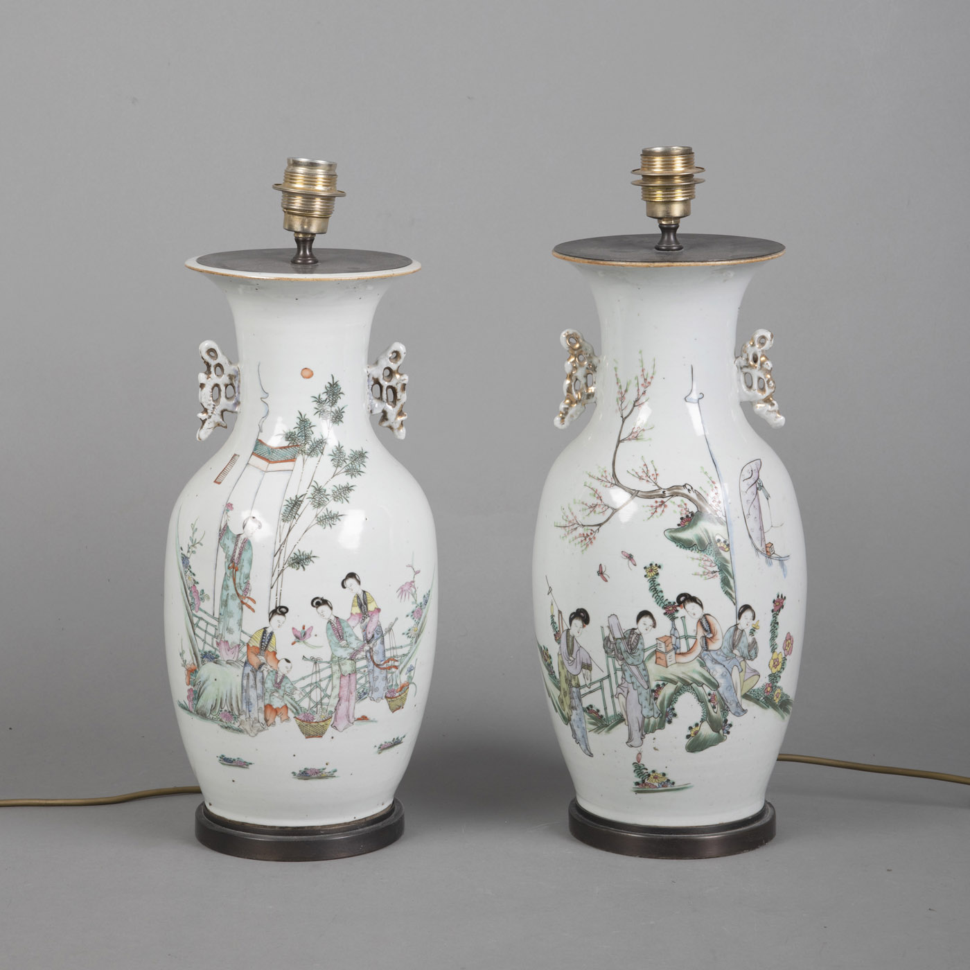 <b>A PAIR OF POLYCHROME PAINTED PORCELAIN VASES DEPICTING LADIES IN A GARDEN, MOUNTED AS LAMPS</b>