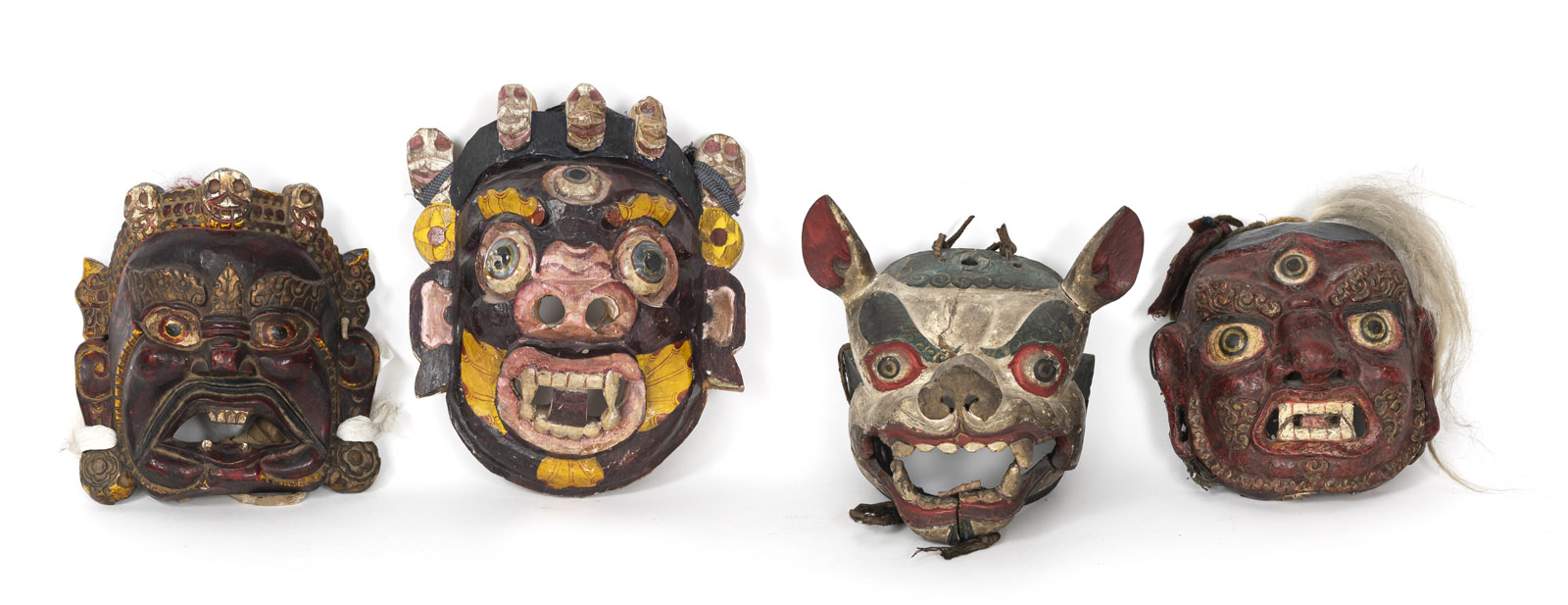 <b>Vier dämonische, polychrom bemalte Holz- und Pappmaché-Masken</b>