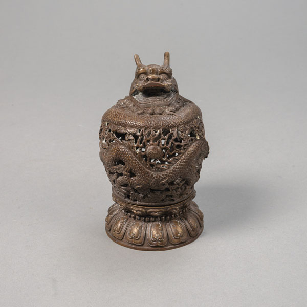 <b>TWO-PART BRONZE INCENSE BURNER: COVER IN DRAGON SHAPE IN OPENWORK AND A LOTUS BASE</b>