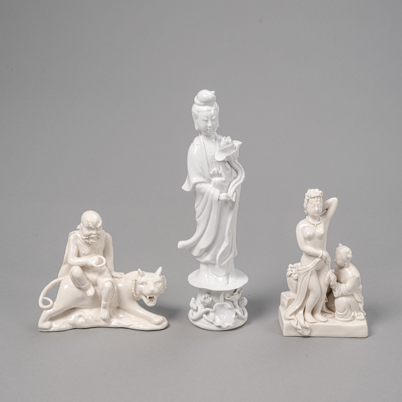 <b>THREE 'BLANC DE CHINE' PORCELAIN FIGURES, E.G. A LUOHAN ON A TIGER</b>