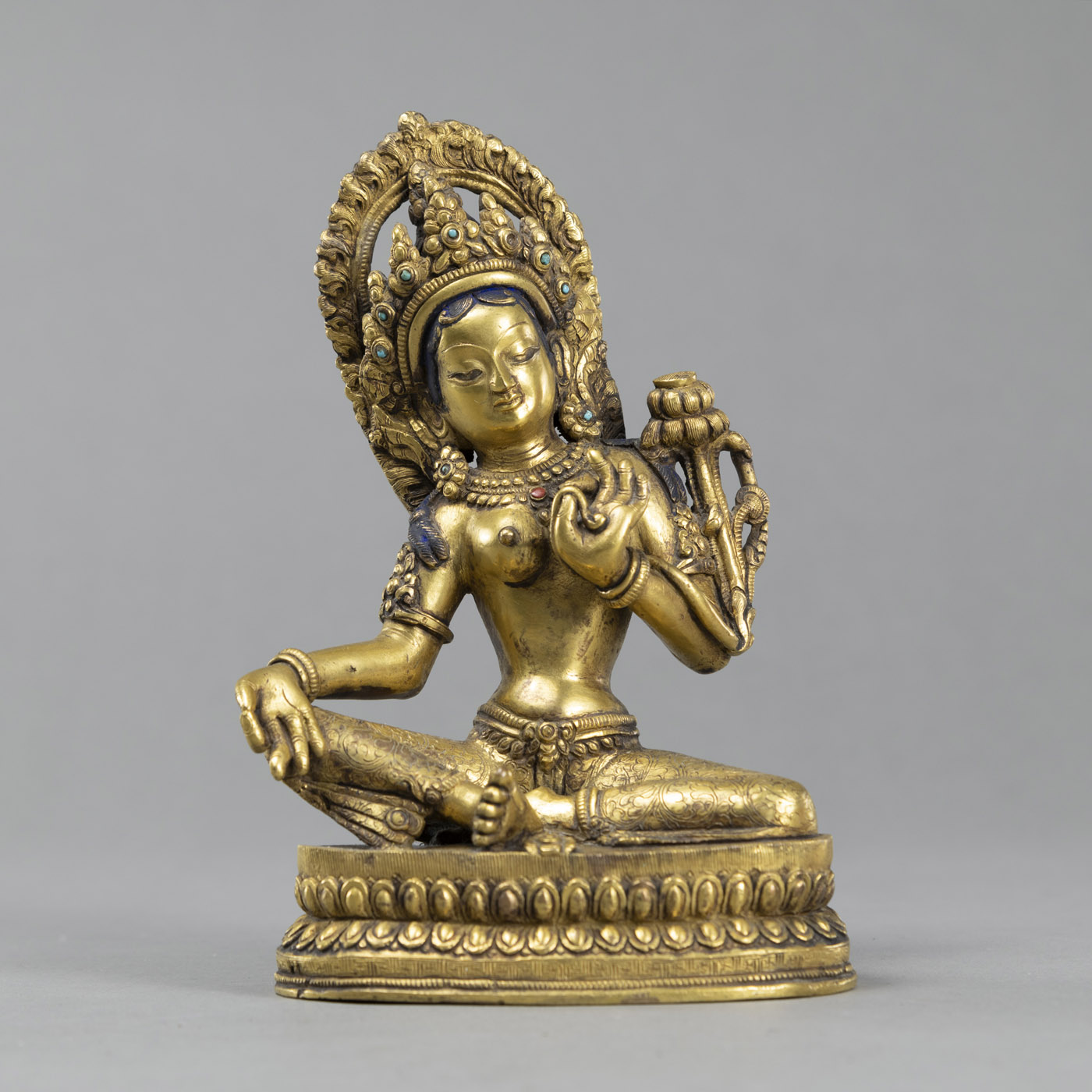 <b>A SEATED GILT BRONZE SEATED TARA WITH STONE INLAY</b>