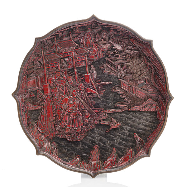 <b>A FINE CARVED BLOSSOM-SHAPED CINNABAR-LACQUER DISH WITH A MYTHOLOGICAL SCENE</b>
