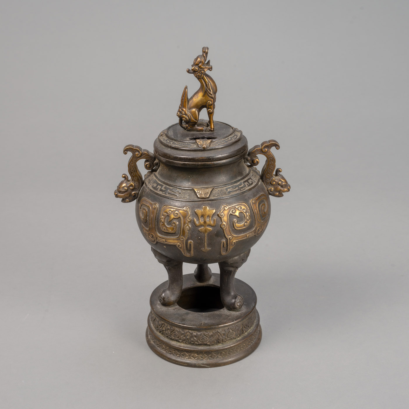 <b>AN ARCHAISTIC BRONZE TRIPOD CENSER WITH 'KIRIN'-HANDLED COVER</b>