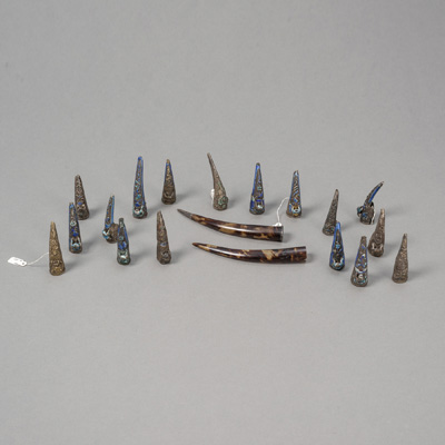 <b>17 NAIL PROTECTORS, PARTLY ENAMELLED ('BURNING BLUE') AND A PAIR OF LONG TORTOISESHELL NAIL PROTECTORS</b>