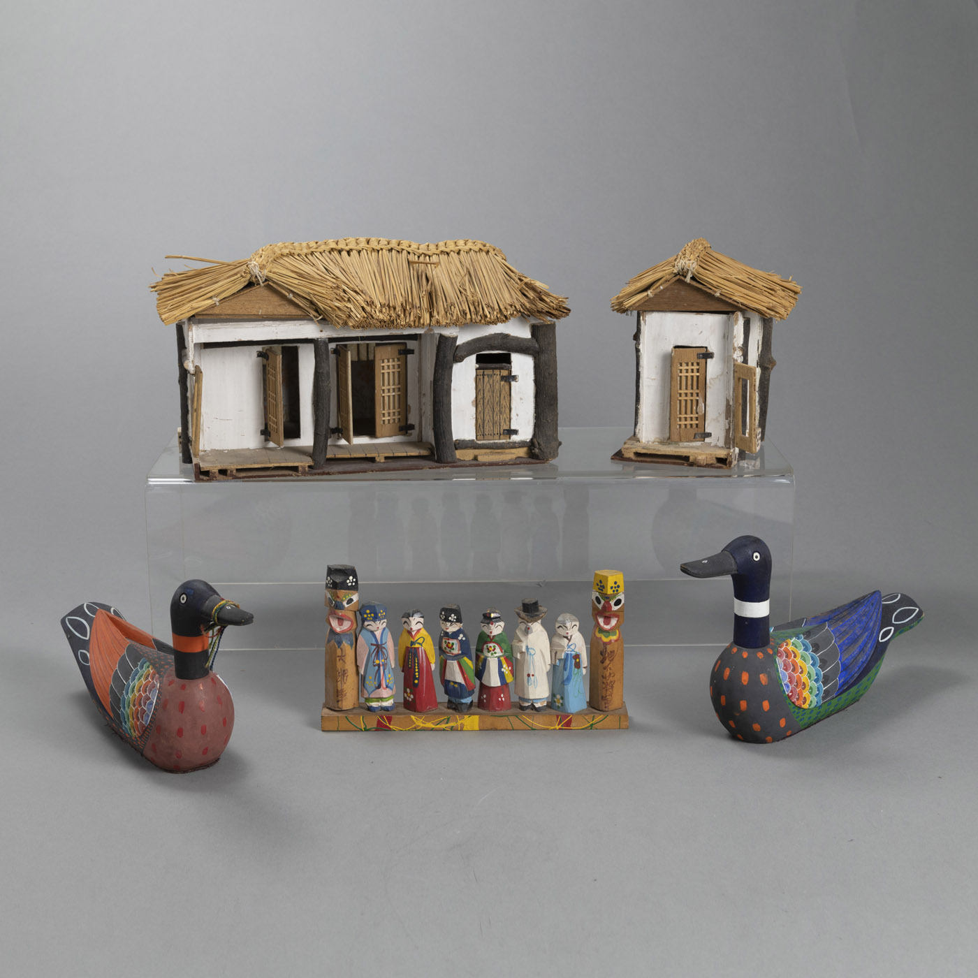 <b>A MODEL OF A YANGBAN HOUSE MADE OF DIFFERENT MATERIALS, A GROUP OF PAINTED WOODEN FIGURES AND A PAIR OF WEDDING DUCKS</b>
