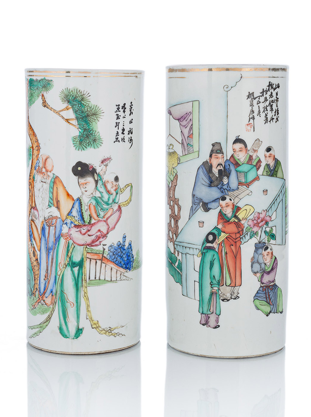 <b>TWO CYLINDRICAL  POLYCHROME PAINTED PORCELAIN HAT STANDS DEPICTING SHOULAO WITH MAGU AND A TEACHING SCENE</b>