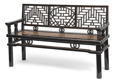<b>A PARTLY BLACK LACQUERED WOODEN BENCH, CARVED IN OPENWORK WITH GEOMETRIC AND RINGS DECORATION, SEATING SURFACE IN BAMBOO IMITATION</b>