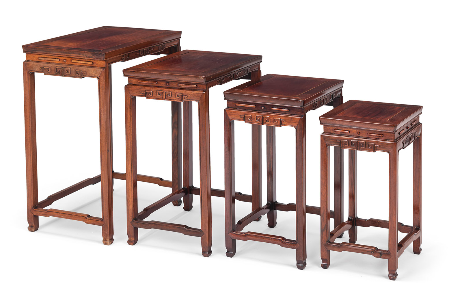 <b>A SET OF FOUR RECTANGULAR KEYFRET APRON NESTING TABLES</b>