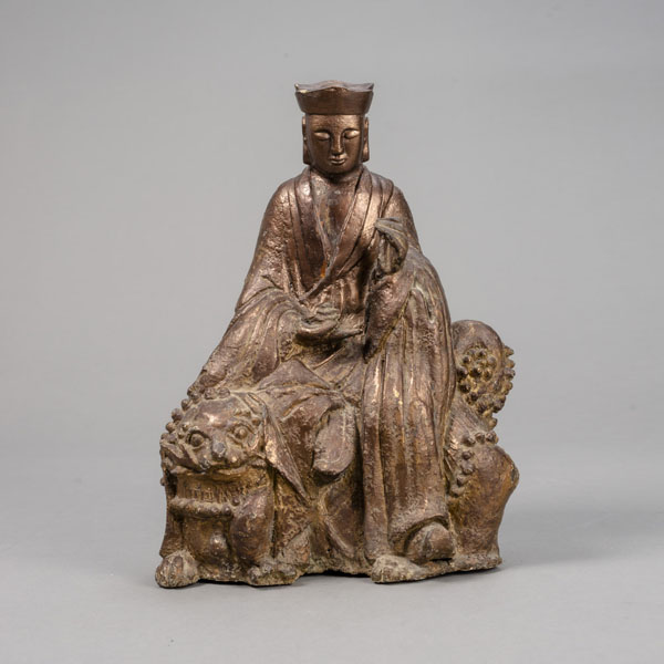 <b>A BRONZE FIGURE OF A MONK SEATED ON A FO LION</b>