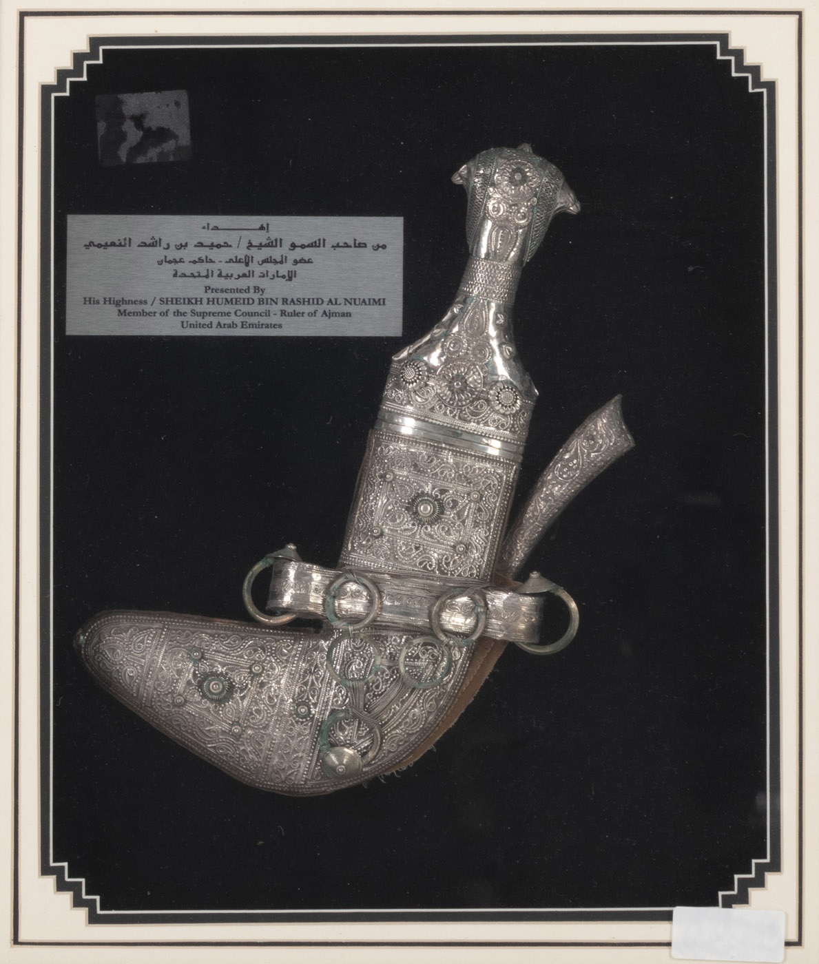 <b>A JAMBIYA DAGGER WITH SILVER APPLIQUE WORK WITHIN A FRAME</b>