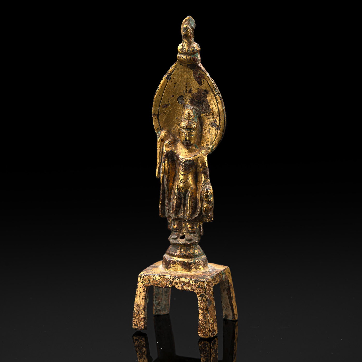 <b>A GILT-BRONZE FIGURINE OF STANDING AVALOKITESHVARA HOLDING A FLASK</b>