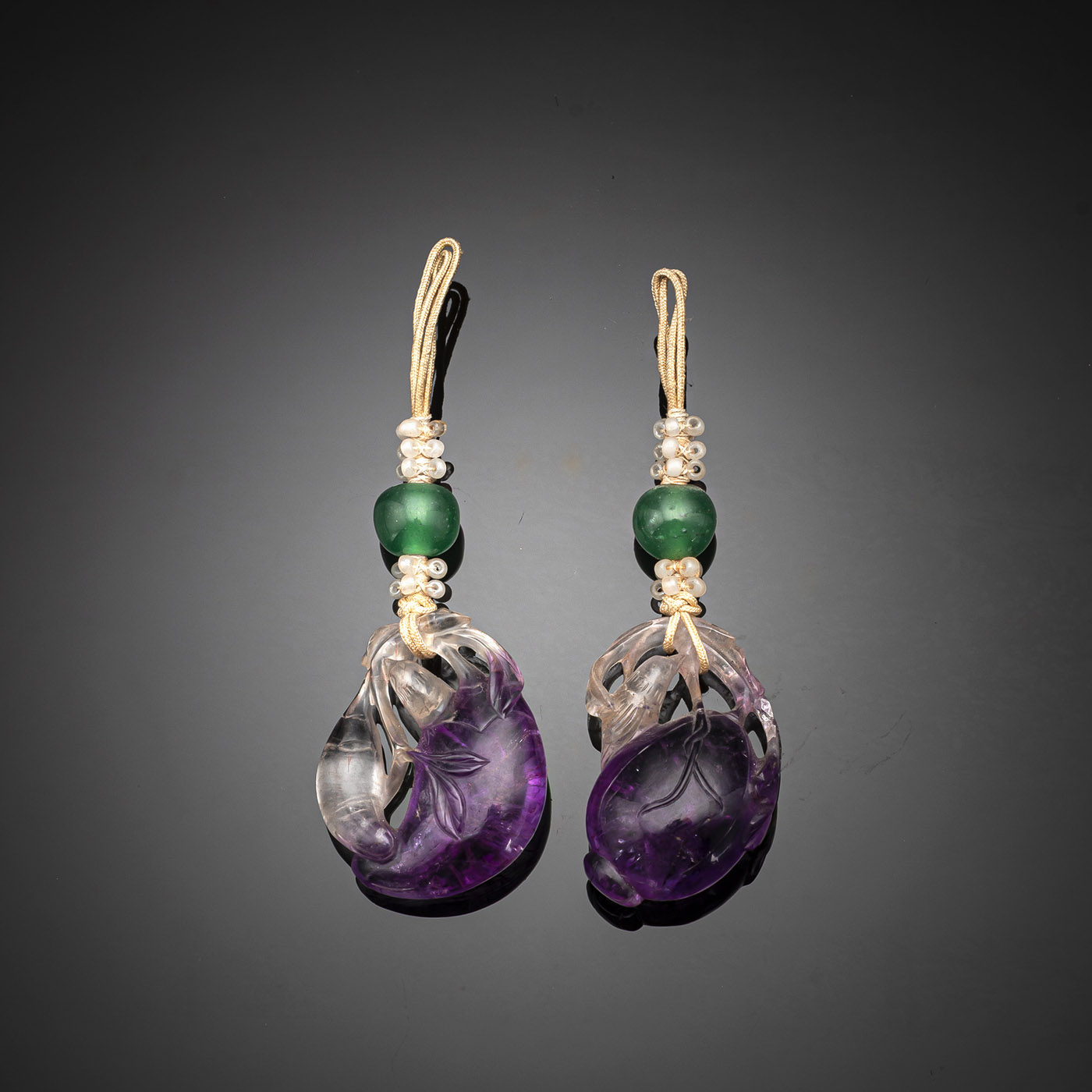<b>A PAIR OF FINELY CARVED AMETHYST PENDANTS</b>