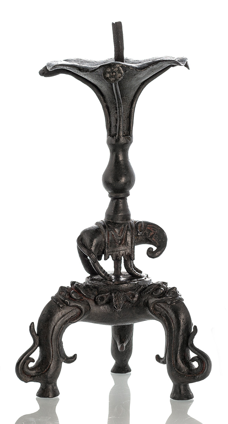 <b>A FOOTED BRONZE CANDLESTICK WITH A WICK HOLDER</b>
