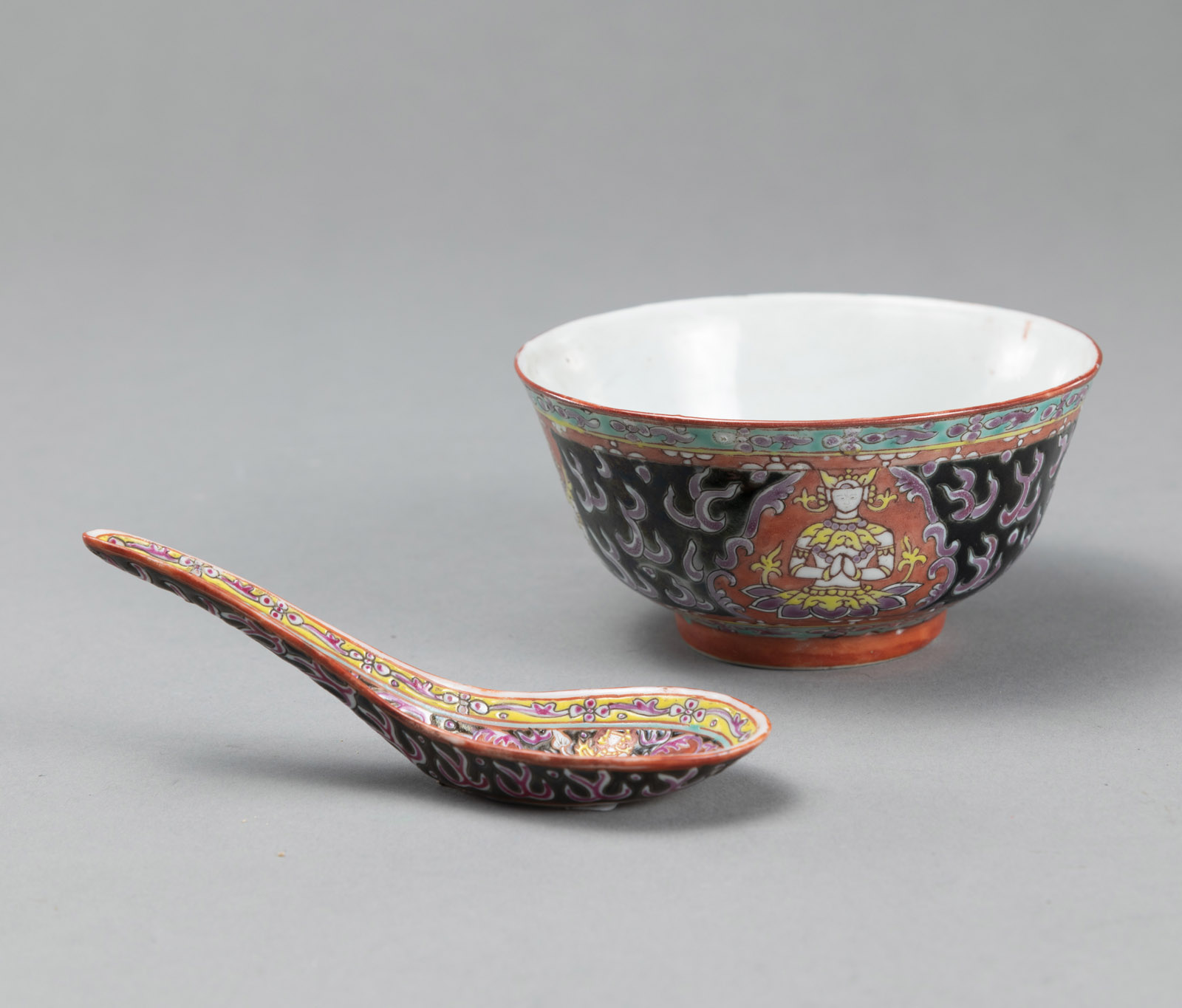 <b>A BENCHARONG BOWL AND A SPOON DEPICTING THEPANOM AND NORASINGH ON A BLACK GROUND WITH KRANOK FLAMES</b>