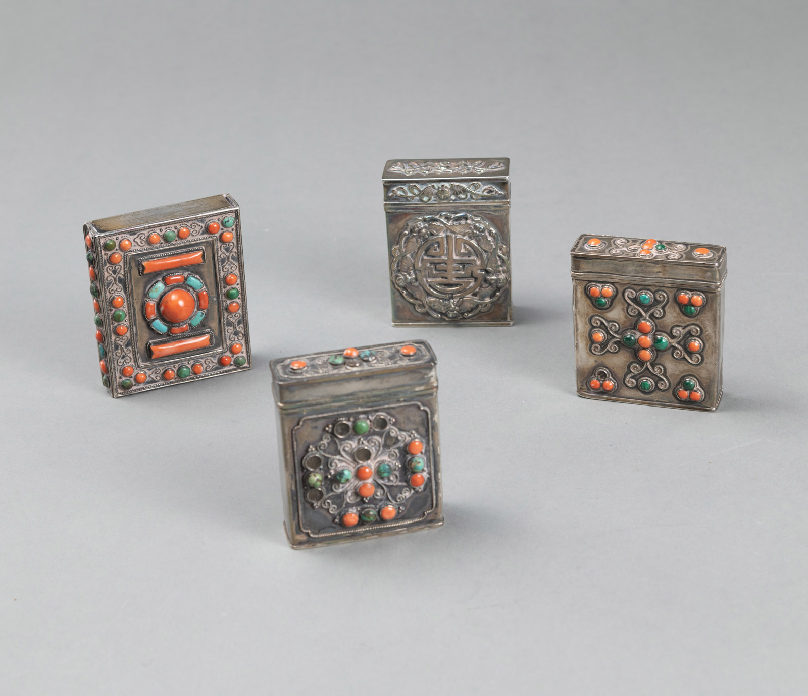 <b>FOUR PARTIALLY CORAL- AND TURQUOISE-INLAID METAL BOXES</b>