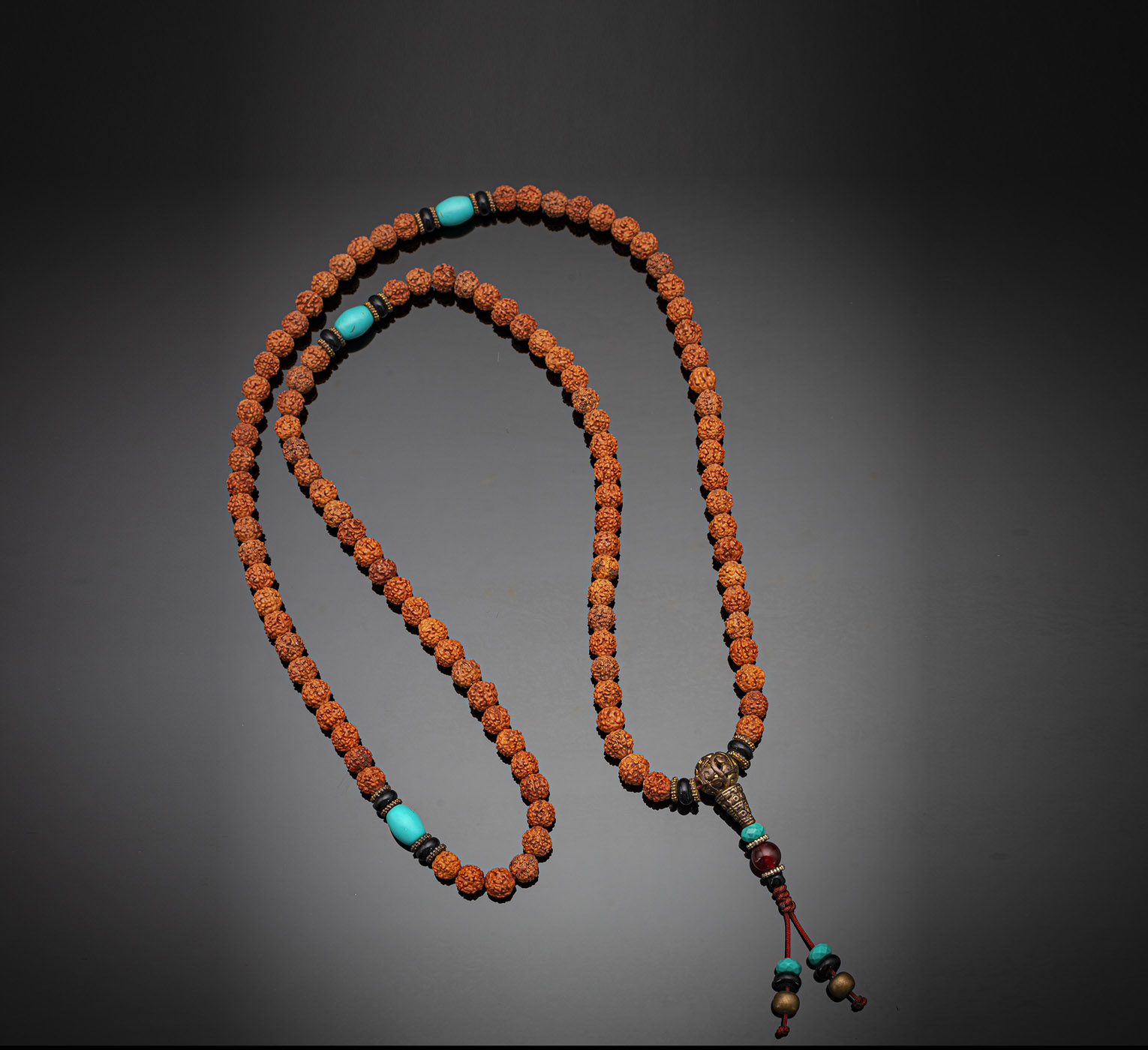 <b>A NECKLACE WITH 108 FRUIT SEEDS WITH GLASS, STONE AND BRONZE BEADS</b>