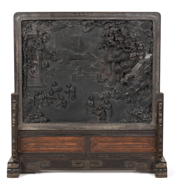 <b>A WOODEN TABLE SCREEN DEPICTING CHILDREN PLAYING IN A GARDEN IN RELIEF AND LUCKY SYMBOLS IN GOLD PAINTING</b>