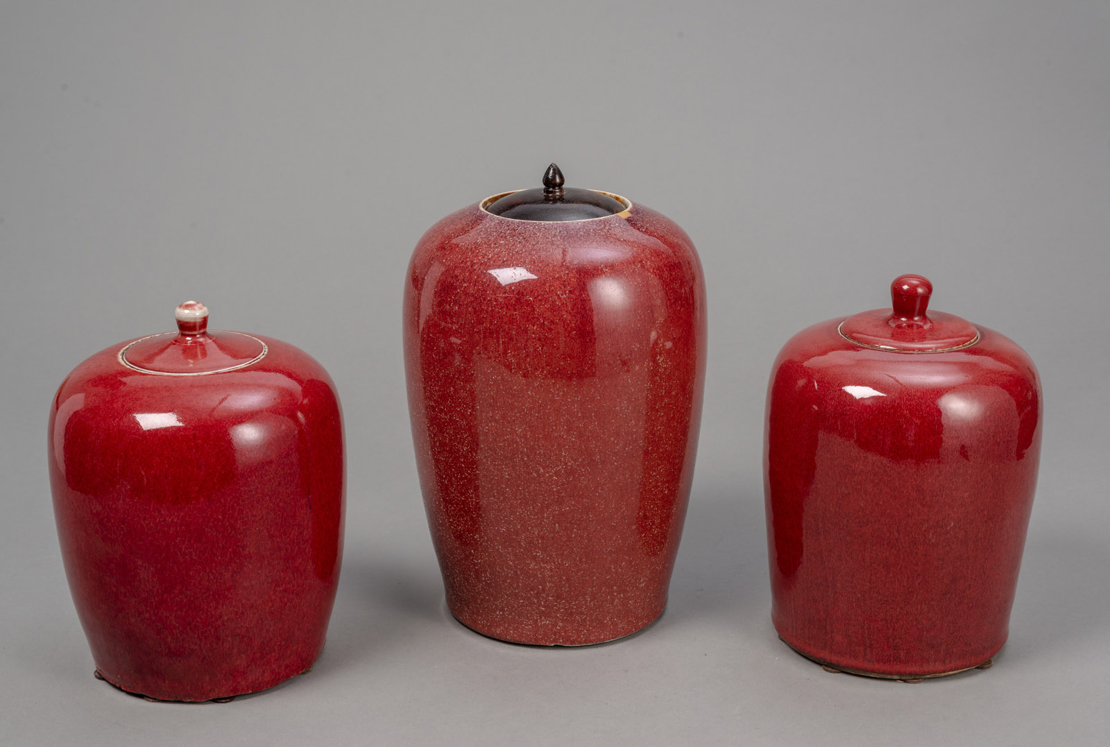 <b>THREE OXBLOOD-GLAZED GINGER JARS</b>