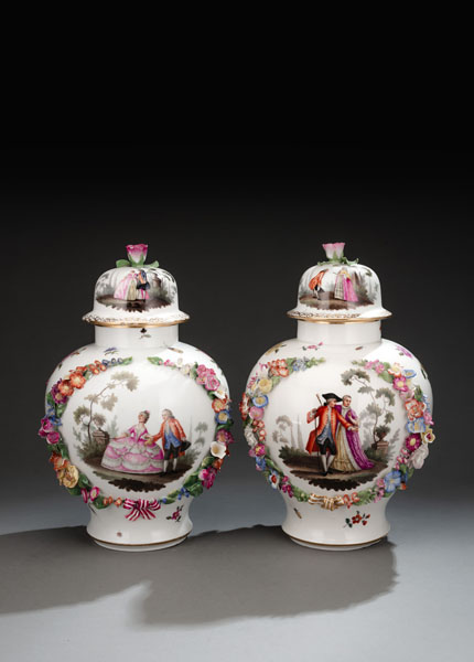 <b>A PAIR OF FLORAL TOOLED VASES AND COVERS</b>