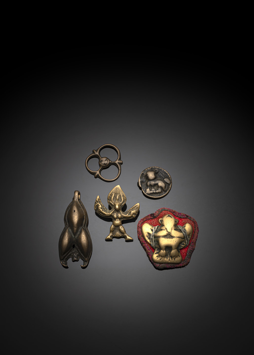 <b>A GROUP OF FIVE 'THOKCHA' PENDANTS</b>