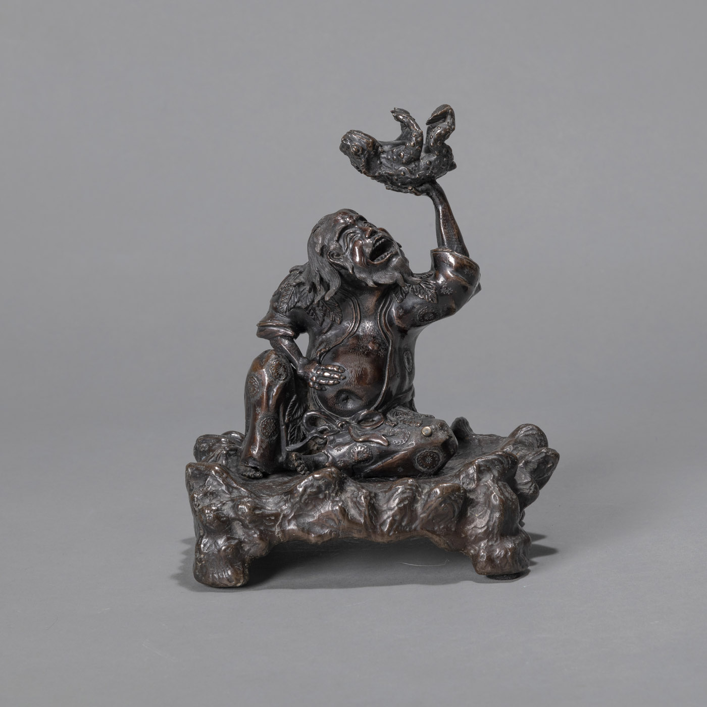 <b>A BRONZE OKIMONO OF GAMA SENNIN HOLDING HIS TOAD</b>