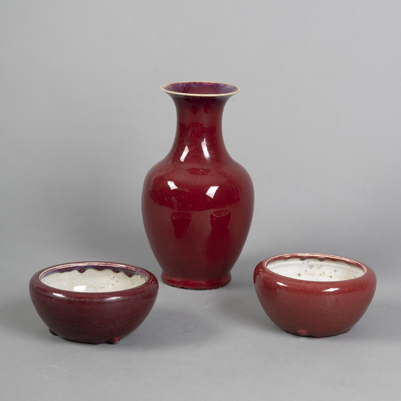 <b>A OXBLOOD GLAZED ZUN-SHAPED VASE AND TWO BRUSH WASHERS</b>