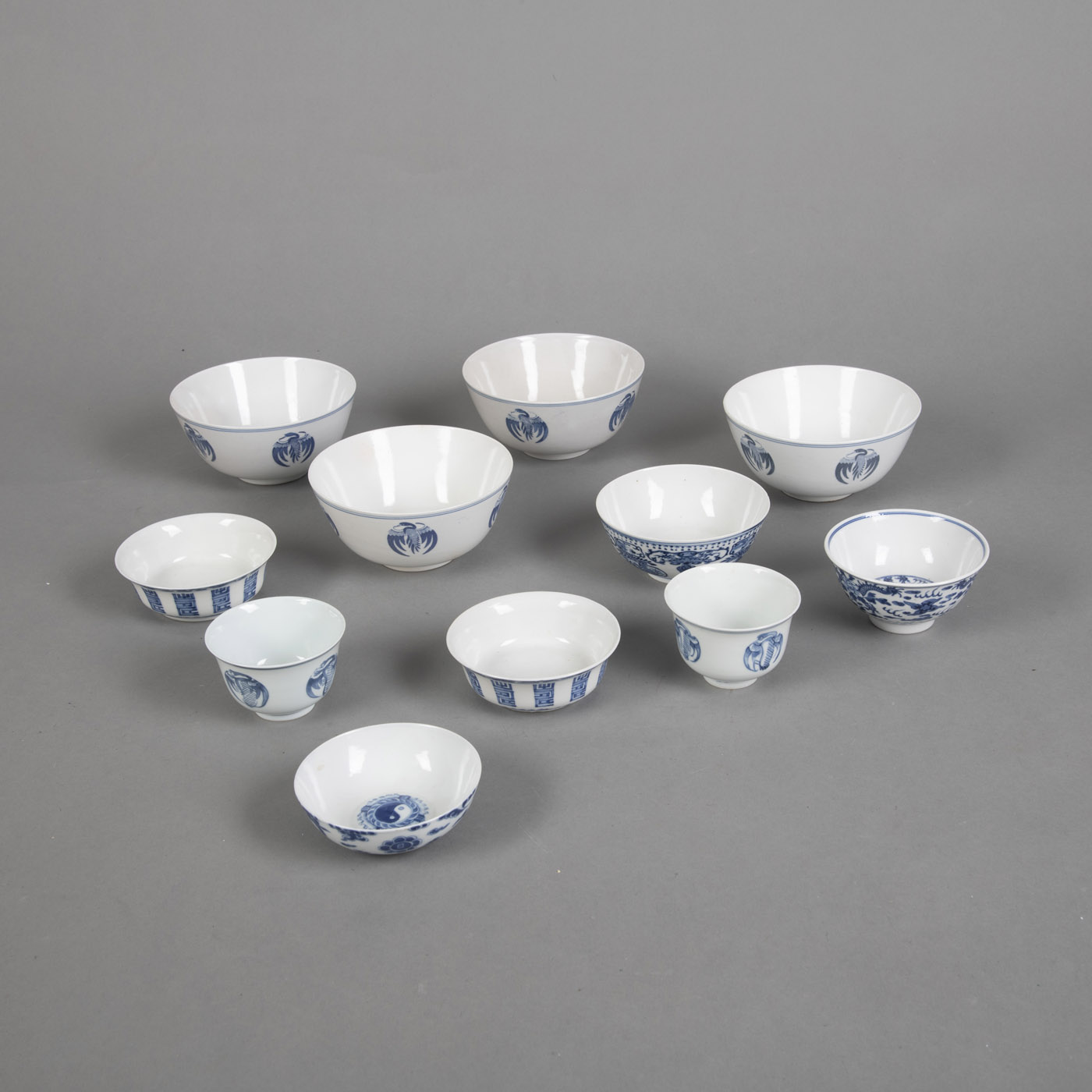 <b>A GROUP OF ELEVEN PORCELAIN BOWLS DECORATED WITH UNDERGLAZE BLUE CRANE MEDALLIONS, DRAGONS AND SHOU CHARACTERS</b>