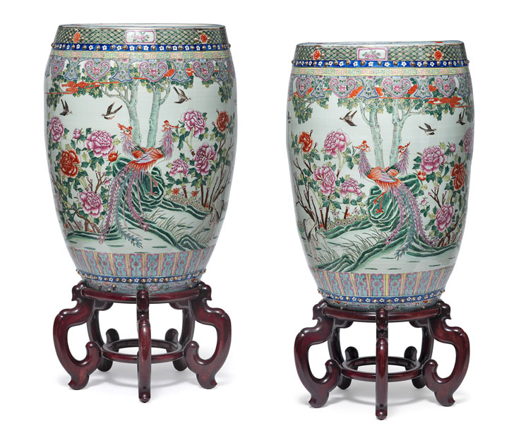 <b>A PAIR OF LARGE DRUM-SHAPED 'FAMILLE ROSE' FISH BASINS DEPICTING PHOENIX BIRDS AND GOLDFISH, MATCHING WOOD STANDS</b>