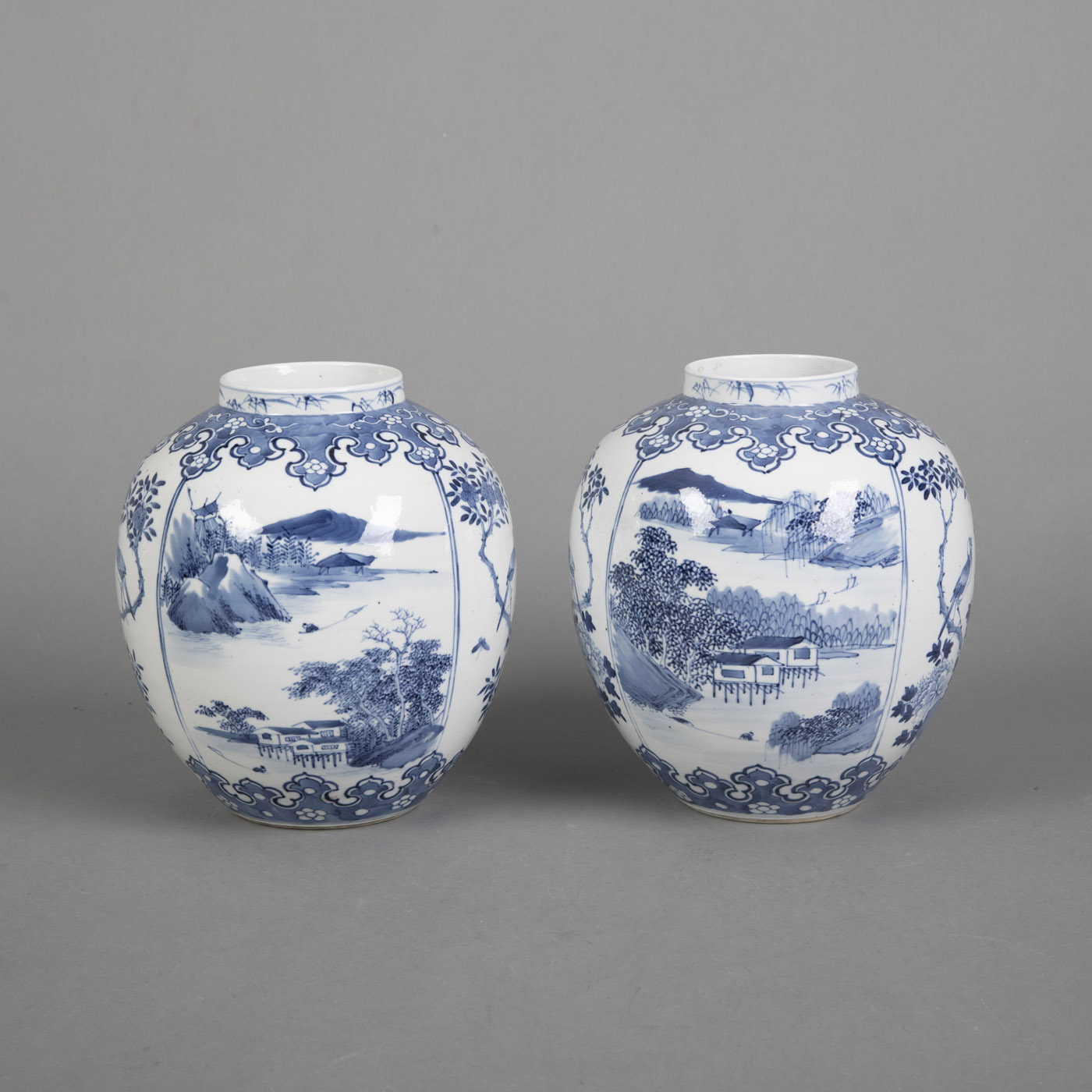 <b>A PAIR OF BLUE AND WHITE LANDSCAPE AND FLORAL PORCELAIN VASES</b>