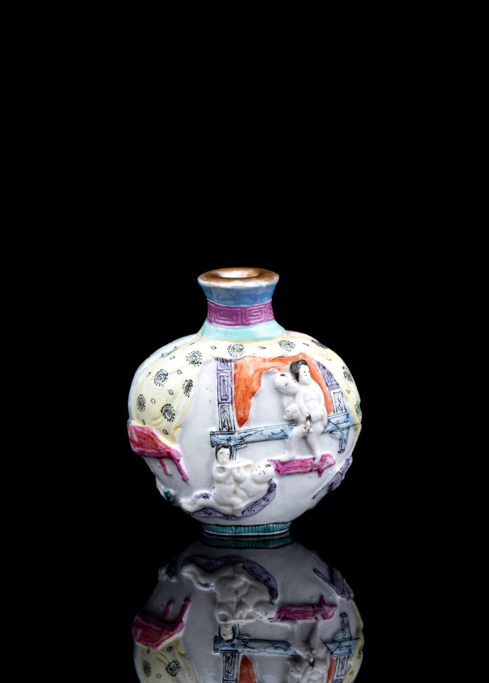 <b>A FAMILLE ROSE MOLDED BISCUIT PORCELAIN SNUFFBOTTLE WITH EROTIC SCENES</b>