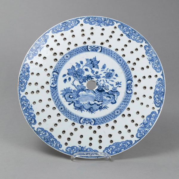 <b>A CIRCULAR BLUE AND WHITE DRAINER WITH FLORAL DECORATION ON THREE SHORT FEET</b>