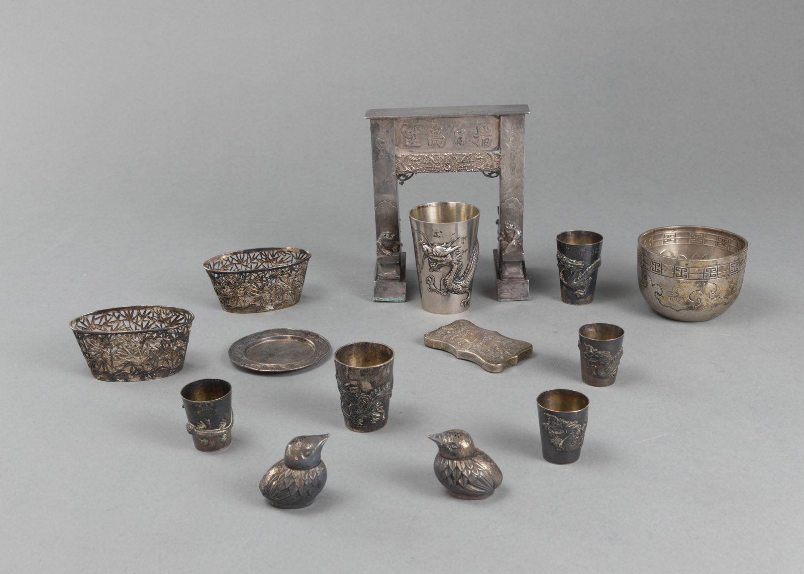 <b>A GROUP OF 14 PIECES OF SILVERWORKS: A MODEL GATE, TWO SALT CELLARS, BOWLS, CUPS, A CARD CASE</b>