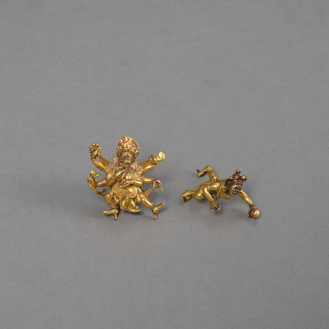 <b>TWO MINIATURE GILT-BRONZE FIGURES OF MAHAKALA AND A CONSORT</b>