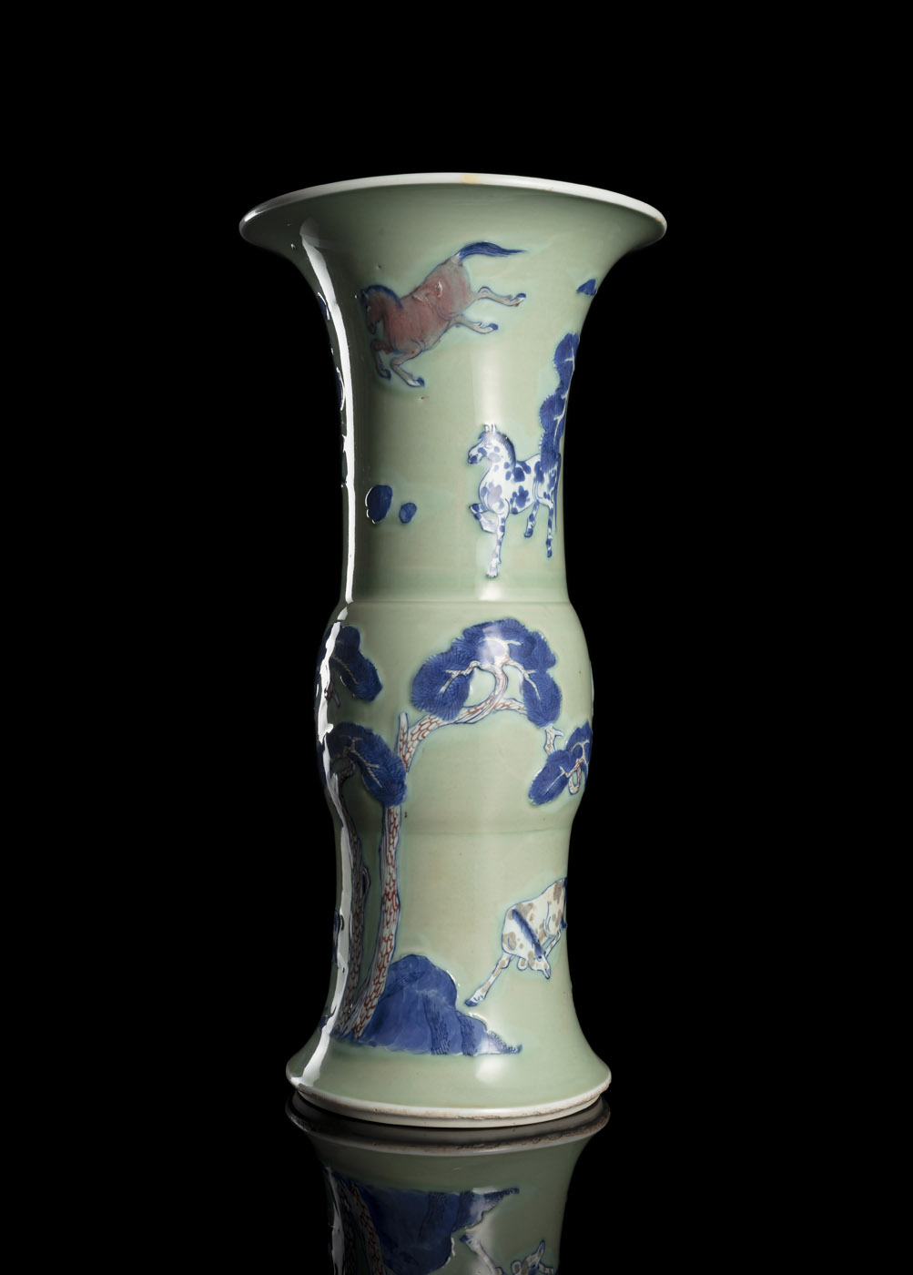 <b>A CELADON-GROUND COPPER-RED AND BLUE AND WHITE EIGHT HORSES AND PINE GU-SHAPED VASE</b>
