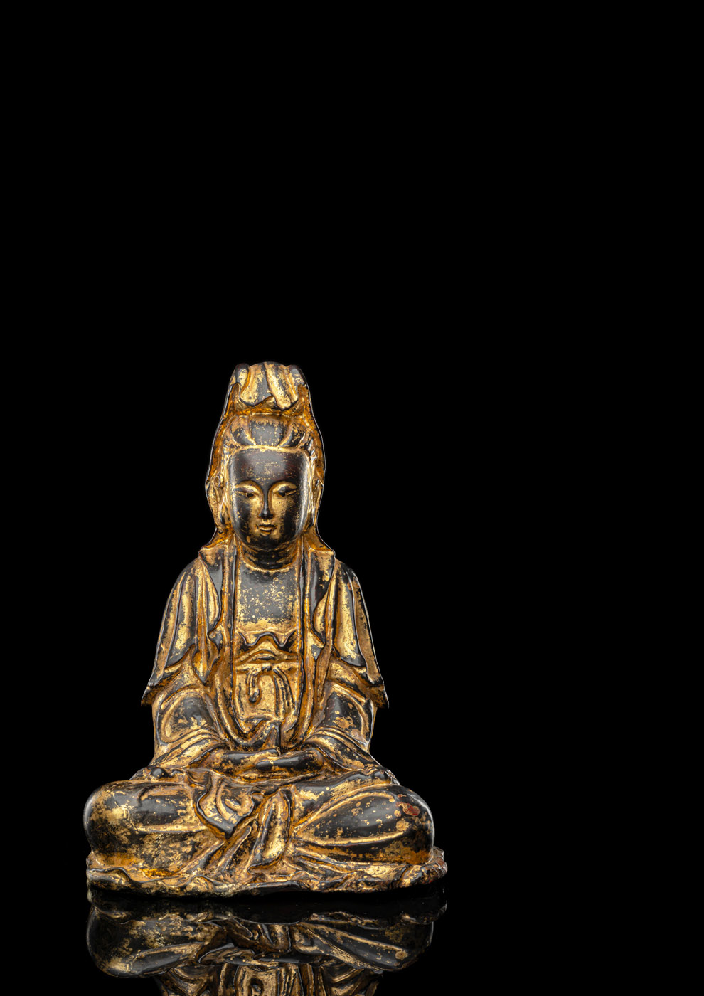 <b>A GILT- AND BLACK-LACQUERED BRONZE FIGURE OF GUANYIN</b>