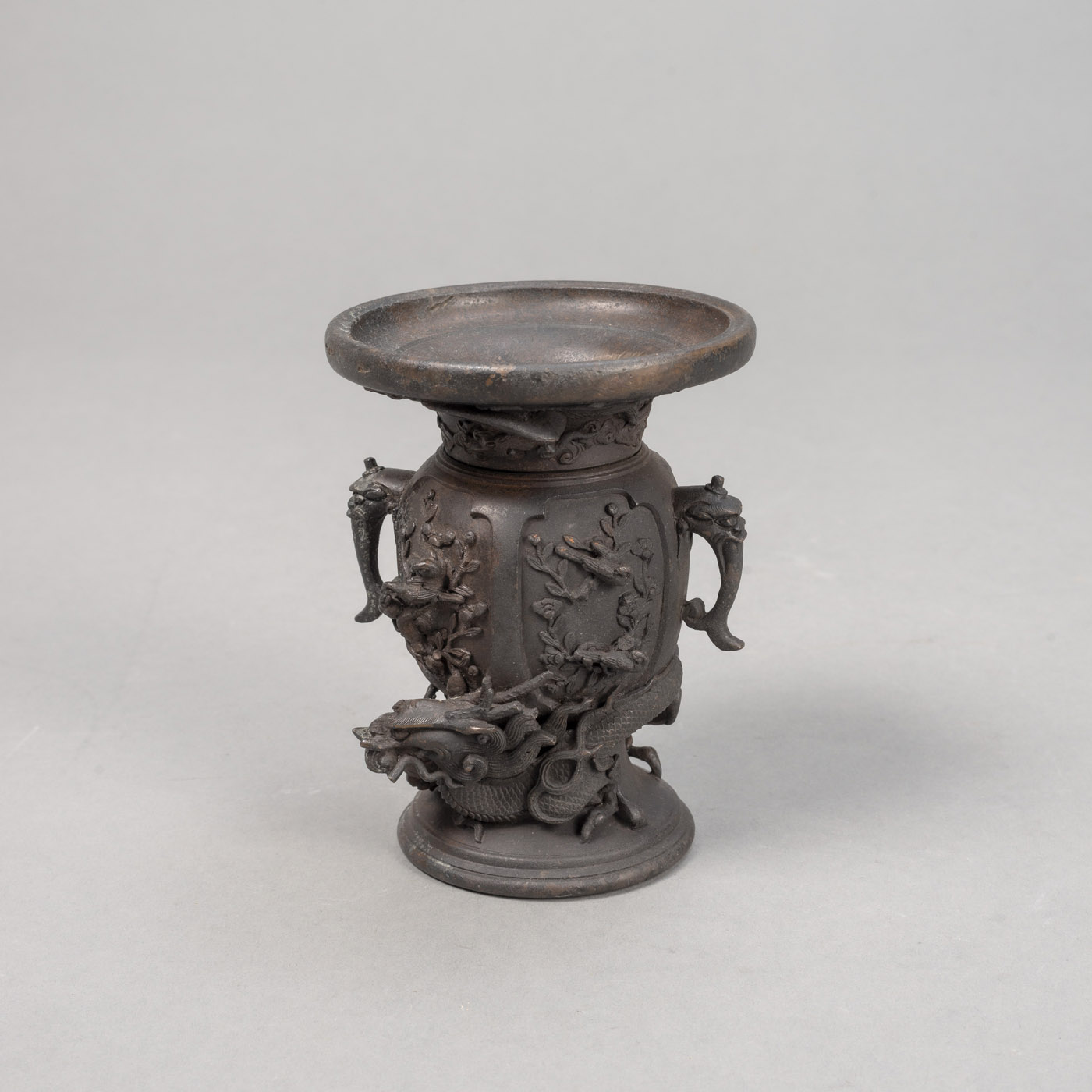 <b>A SMALL TWIN-HANDLED HIGH RELIEF DRAGON BRONZE VASE</b>