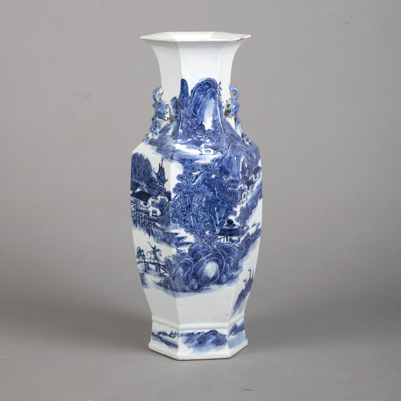 <b>A HEXAGONAL BLUE AND WHITE LANDSCAPE PORCELAIN VASE WITH PEACH HANDLES</b>