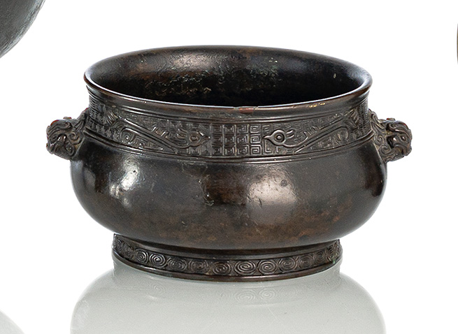 <b>A WELL CAST BRONZE CENSER WITH MASK HANDLES</b>