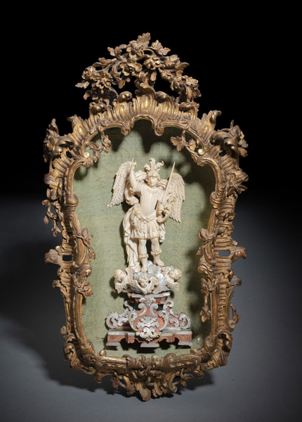 <b>A FINELY CARVED IVORY FIGURE OF ST. MICHAEL IN A DECORATIVE FRAME</b>