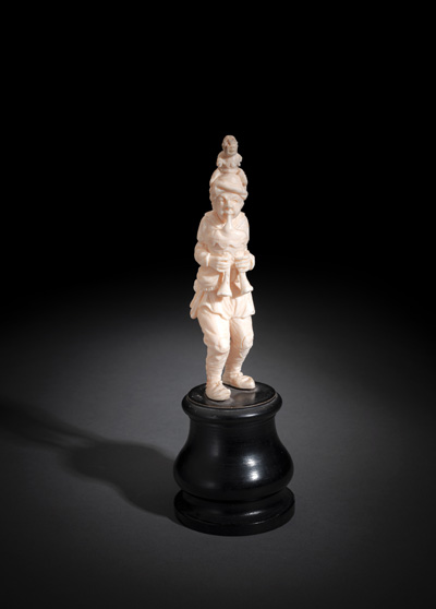 <b>A CARVED IROY FIGURE OF A BAGPIPER WITH MONKEY</b>