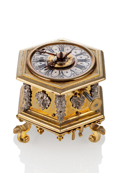 <b>A SMALL BAROQUE GILTBRASS HEXAGONAL HORIZONTAL VERGE CLOCK</b>