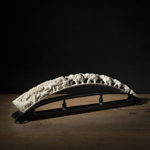 <b>AN IVORY CARVED BRIDGE WITH ELEPHANTS AND OTHER ANIMALS IN THE FOREST, MOUNTED ON A WOOD STAND</b> <b>AN IVORY CARVED BRIDGE WITH ELEPHANTS AND OTHER ANIMALS IN THE FOREST, MOUNTED ON A WOOD STAND</b>